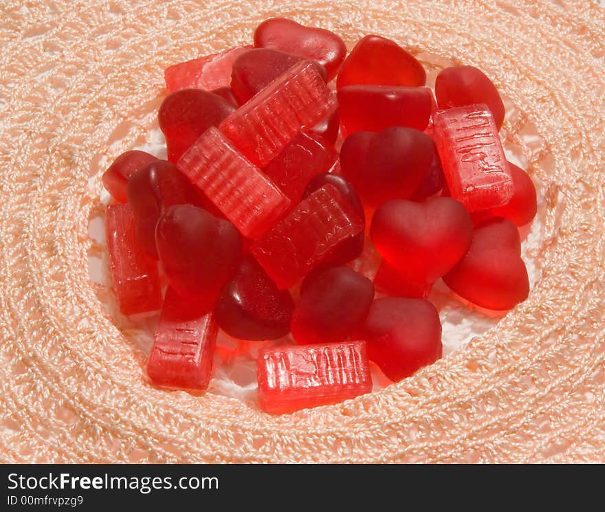 Red marmalade and candy in the form of tiles on napkins. Red marmalade and candy in the form of tiles on napkins