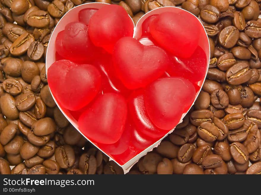 Red marmalade, in the form of hearts against the backdrop of coffee beans. Red marmalade, in the form of hearts against the backdrop of coffee beans