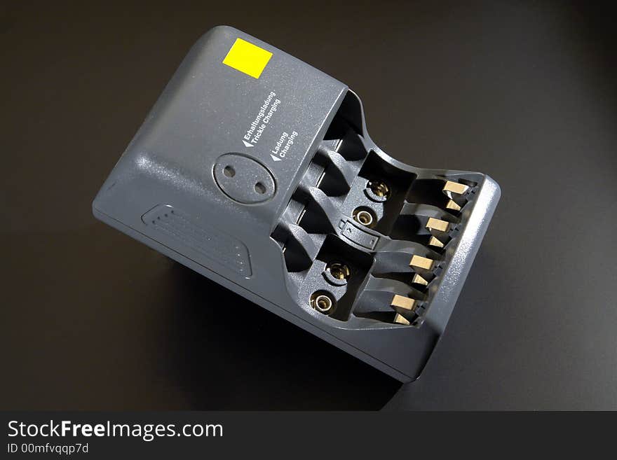 A battery charger isolated on black background. Clipping path included