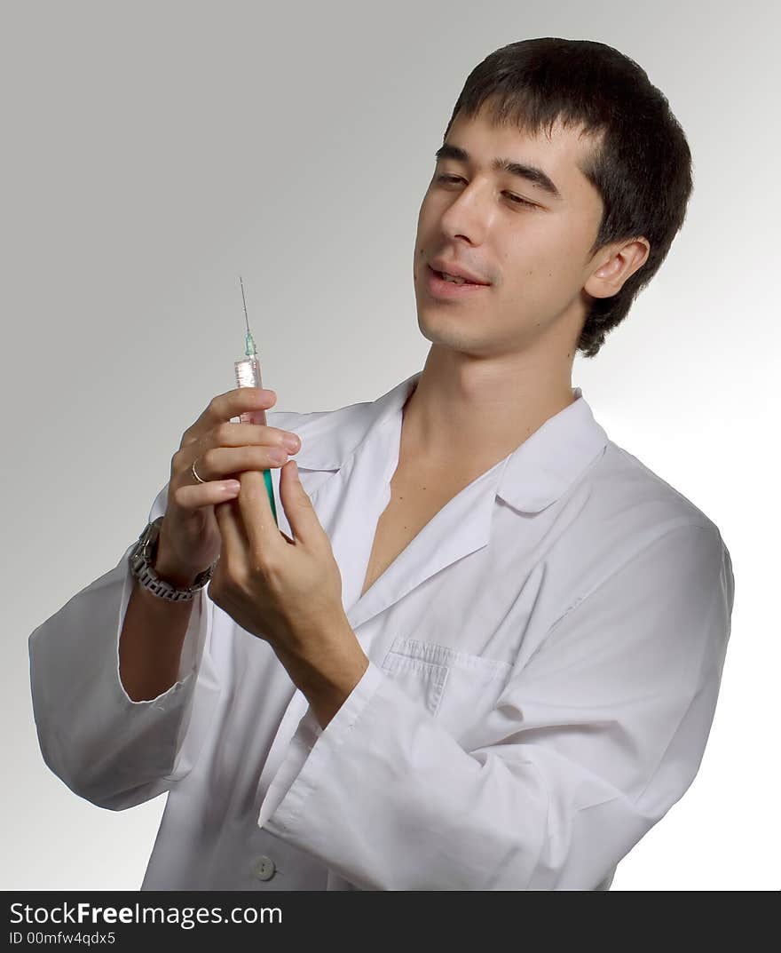 Doctor, preparing to make an injection to the patient in hospital.