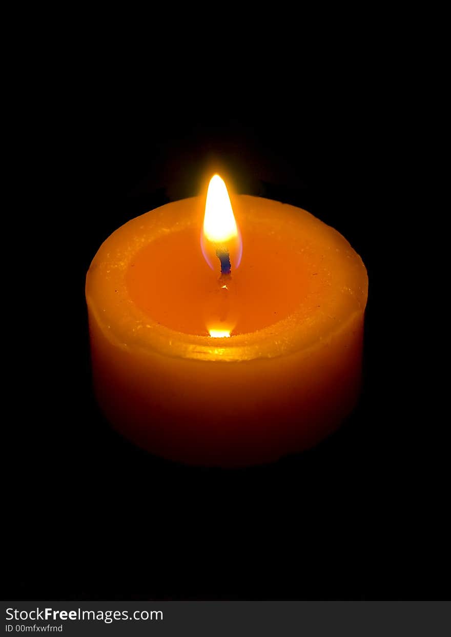 Closeup of a candle with black background.