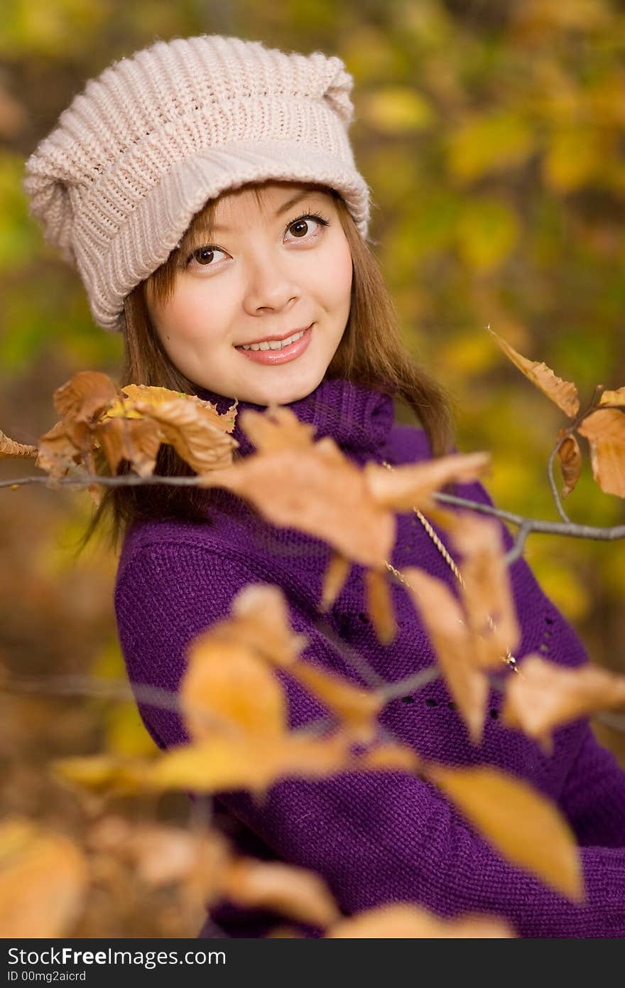 A girl posing in woods with faded leaves. A girl posing in woods with faded leaves