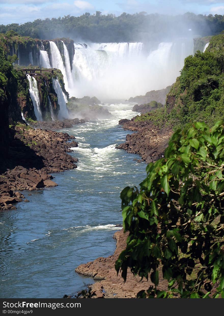 River running through a jungle leading up to a waterfall. River running through a jungle leading up to a waterfall