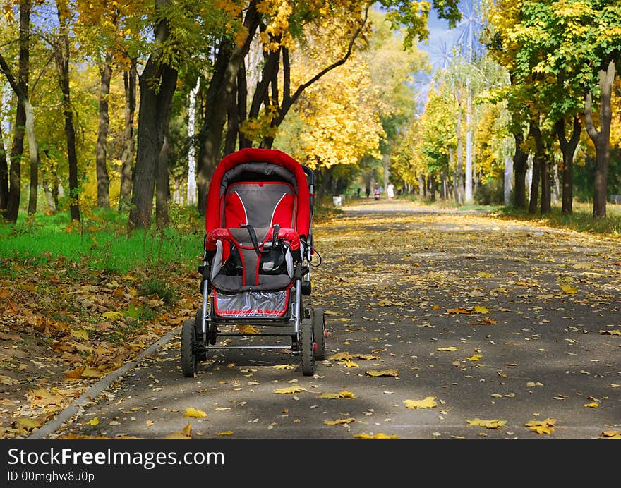 Empty children carriage at autumn park