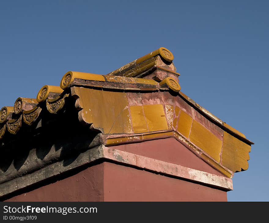 Edge of a chinese temple roof build from yellow tiles. Edge of a chinese temple roof build from yellow tiles