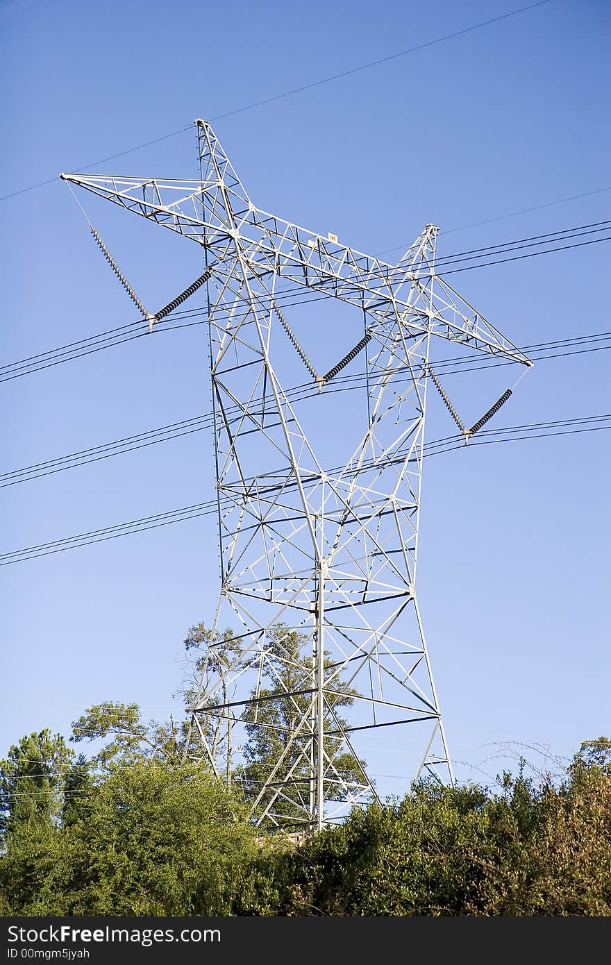 A high power tower against blue sky. A high power tower against blue sky