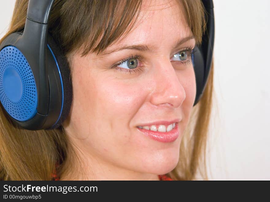 A girl, wearing headphones, listening to some music. A girl, wearing headphones, listening to some music