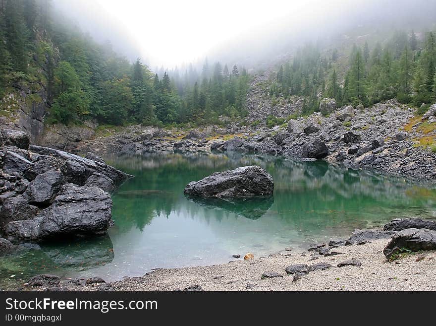 Beautyfull green lake beetween forest and mountains.