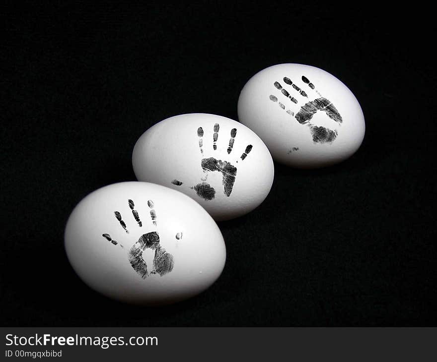 Three whole eggs with smudged hand prints on the shell. Three whole eggs with smudged hand prints on the shell.