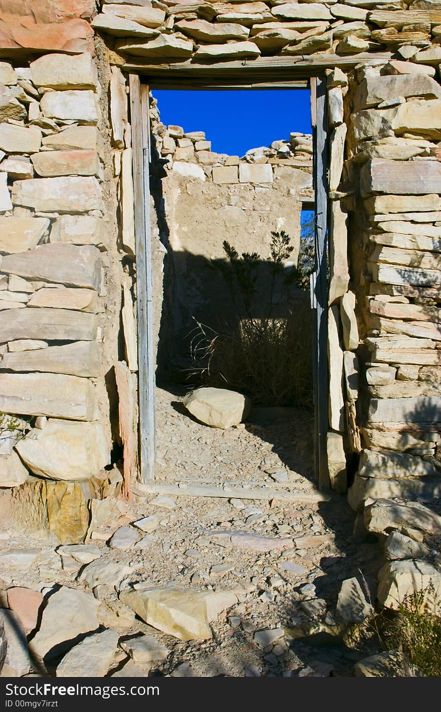 A view through the door of an old abandoned structure built of carefully assembled stones. A view through the door of an old abandoned structure built of carefully assembled stones.