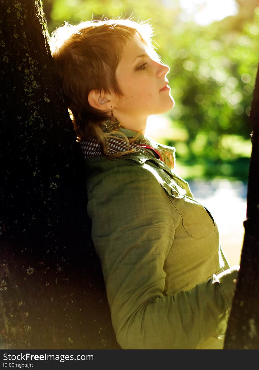 Cute girl in Scarf near tree.