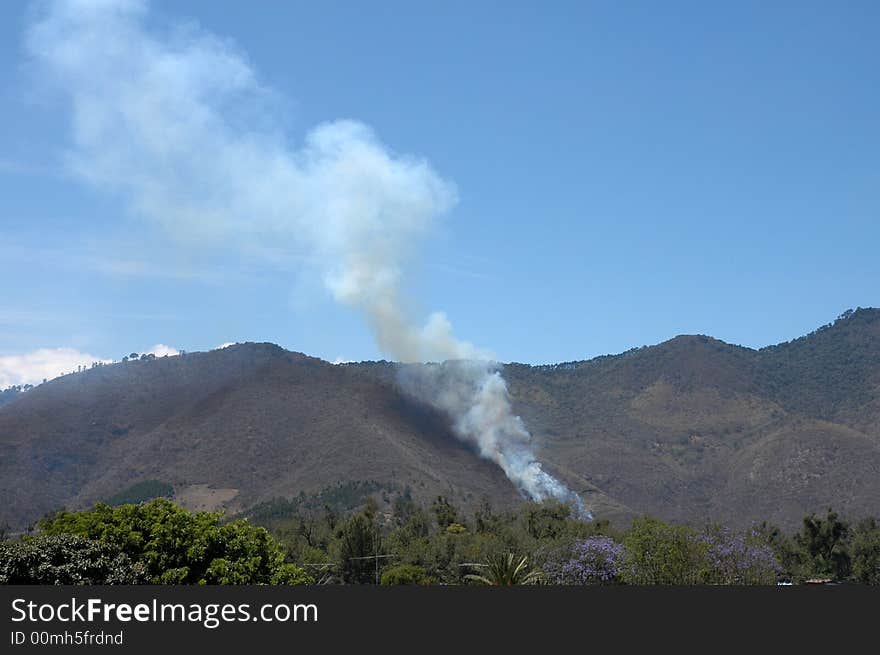 A smoke from a fire in mountains. A smoke from a fire in mountains