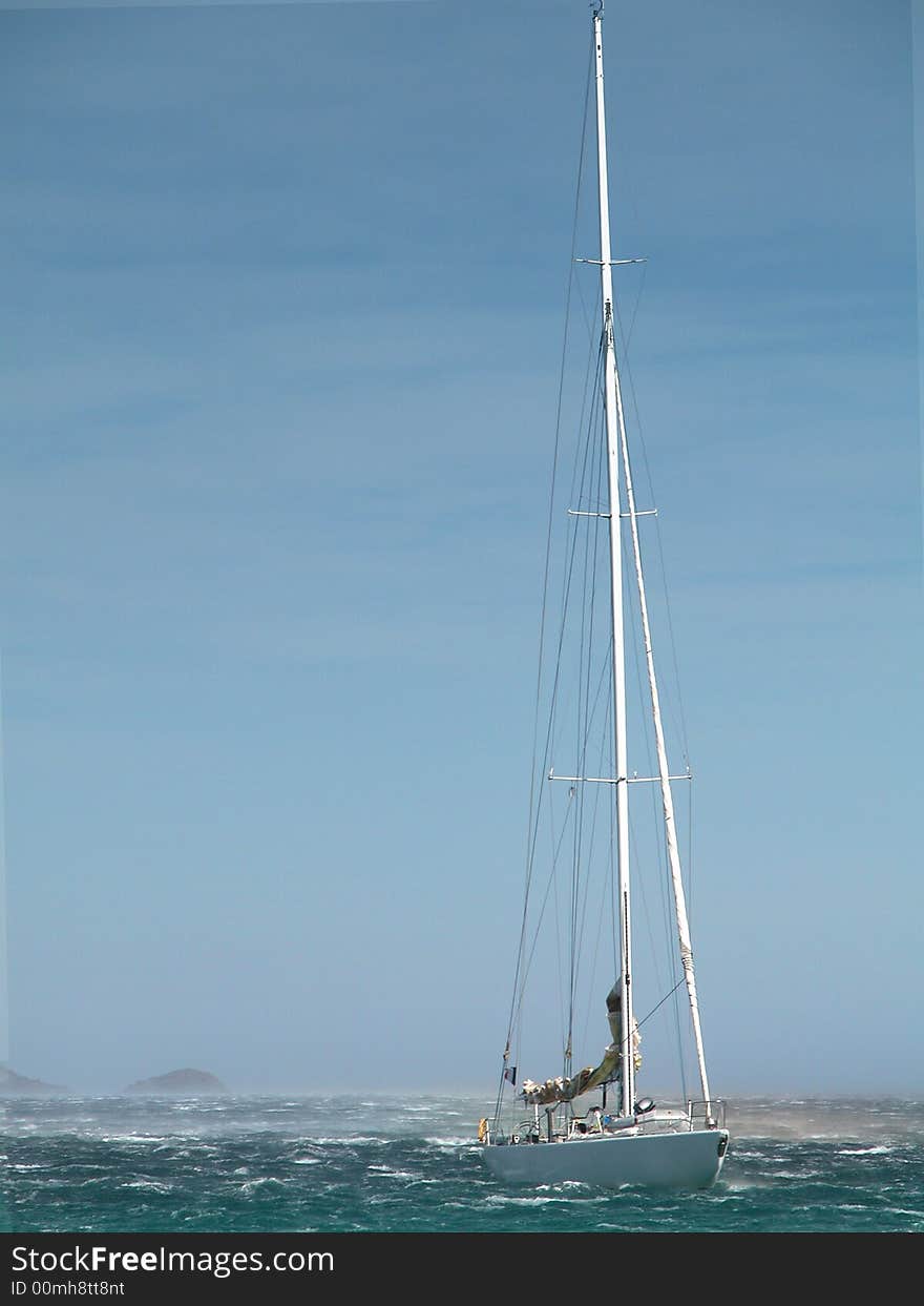 Sailing yacht in stormy weather sea with waves