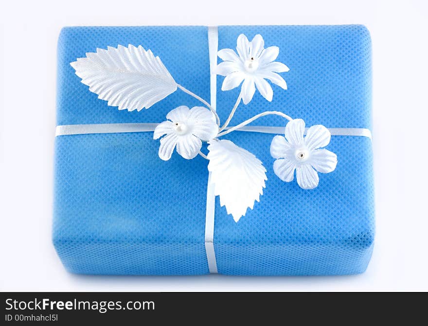 Lightblue gift box with white ribbon isolated on white