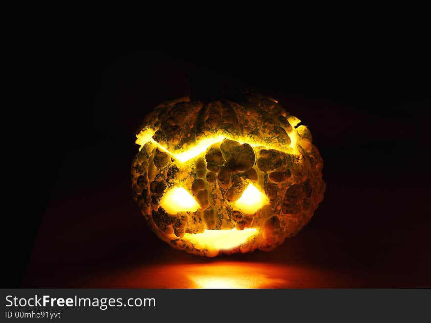 Little pumpkin -candle inside against black background. Little pumpkin -candle inside against black background