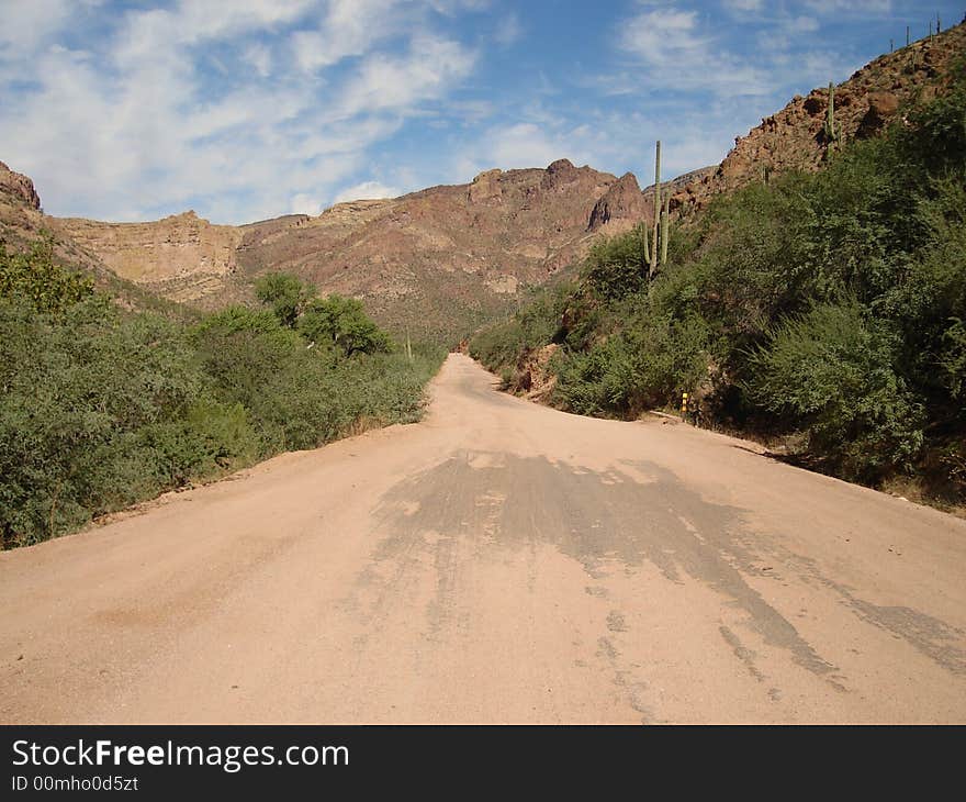 The picture of the dirt road taken on Apache Trail in Arizona. The picture of the dirt road taken on Apache Trail in Arizona.