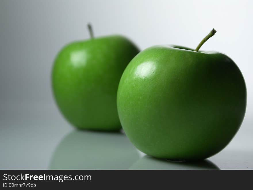 Three green apples on white background