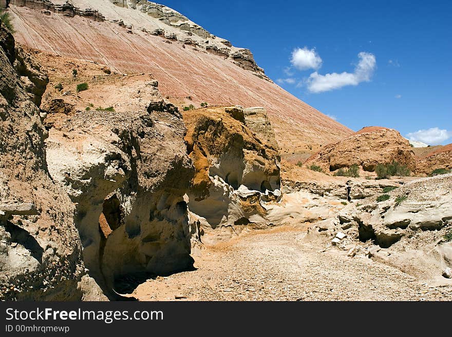 Sandstone and road in desert in hot day in paleontology mountains Aktau, Asia. Sandstone and road in desert in hot day in paleontology mountains Aktau, Asia