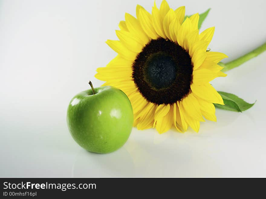 Sunflower and an green apple