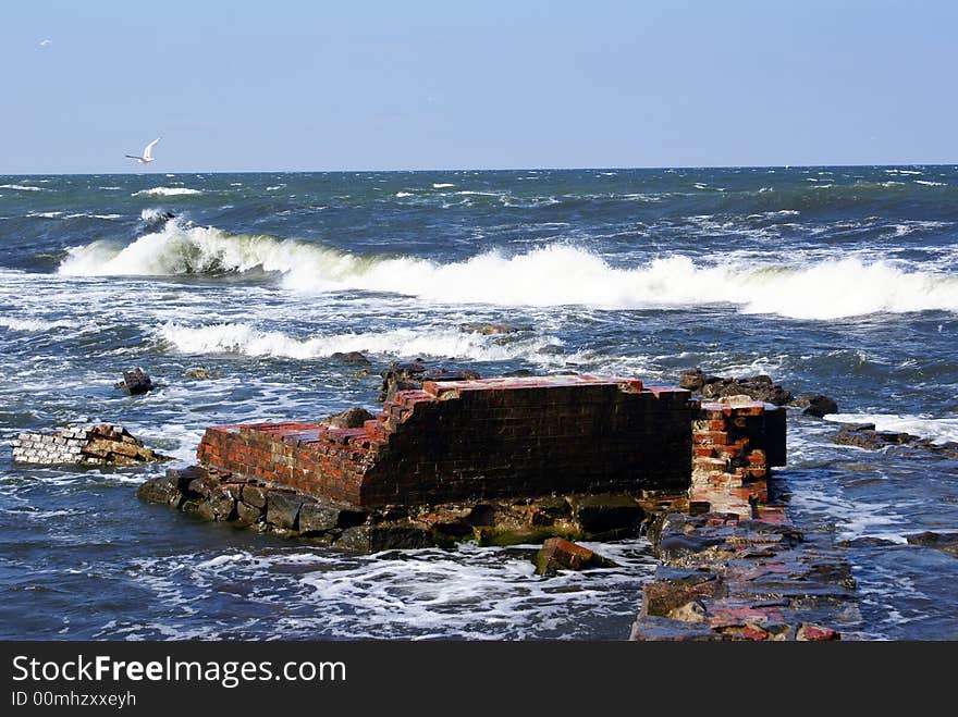 Old brick wall in the water, Baltic sea coast, Russia. Old brick wall in the water, Baltic sea coast, Russia