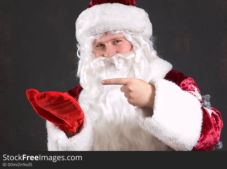 Santa Claus showing onto a red mitten. Santa Claus showing onto a red mitten