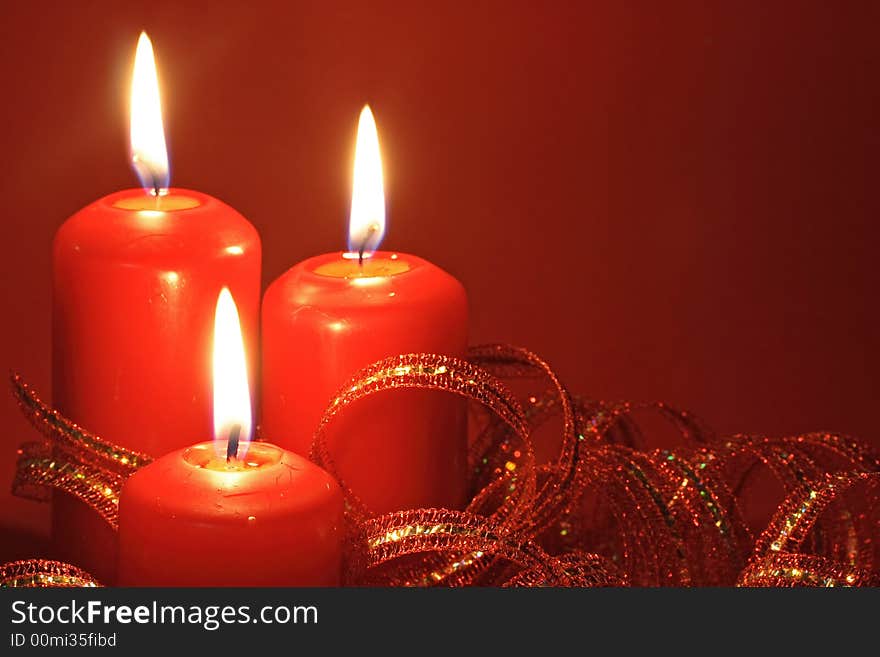 Three candles on red background