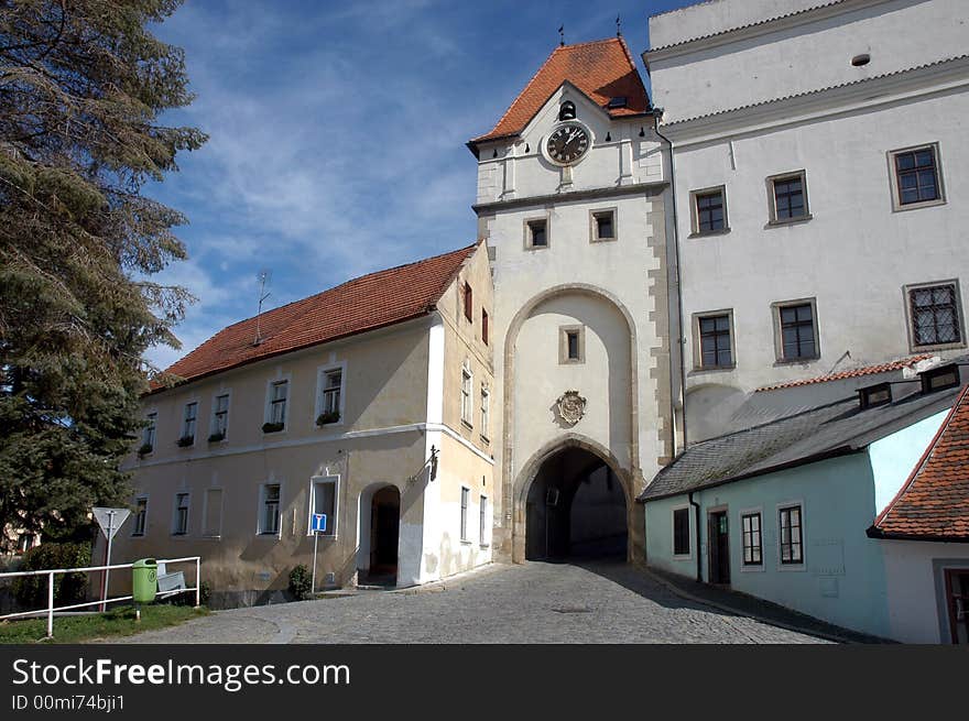 A gateway to a castle with a clock. A gateway to a castle with a clock