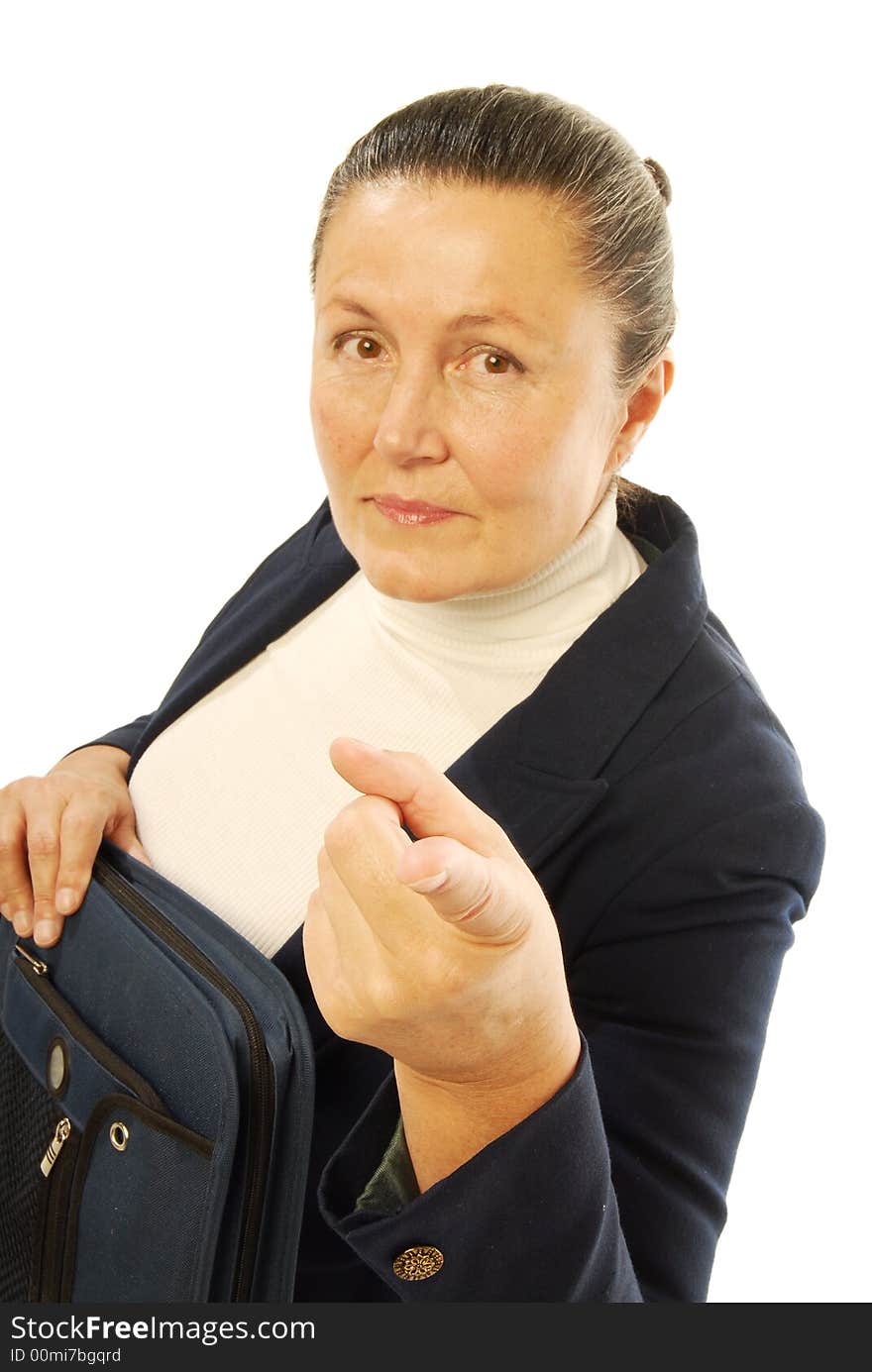 Serious older businesswoman holding a binder and pointing at the camera with the focus on the hand; isolated on white. Serious older businesswoman holding a binder and pointing at the camera with the focus on the hand; isolated on white