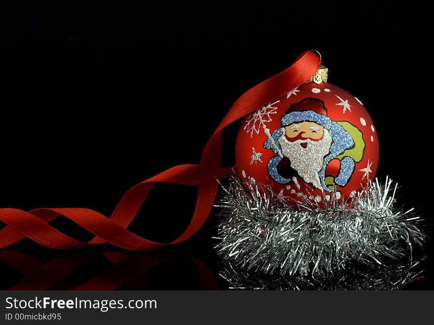 Red christmas tree ball with santa and red ribbon with reflection. Place for text