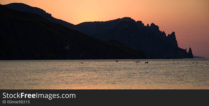 Sun is rising from sea and mountains. Sun is rising from sea and mountains