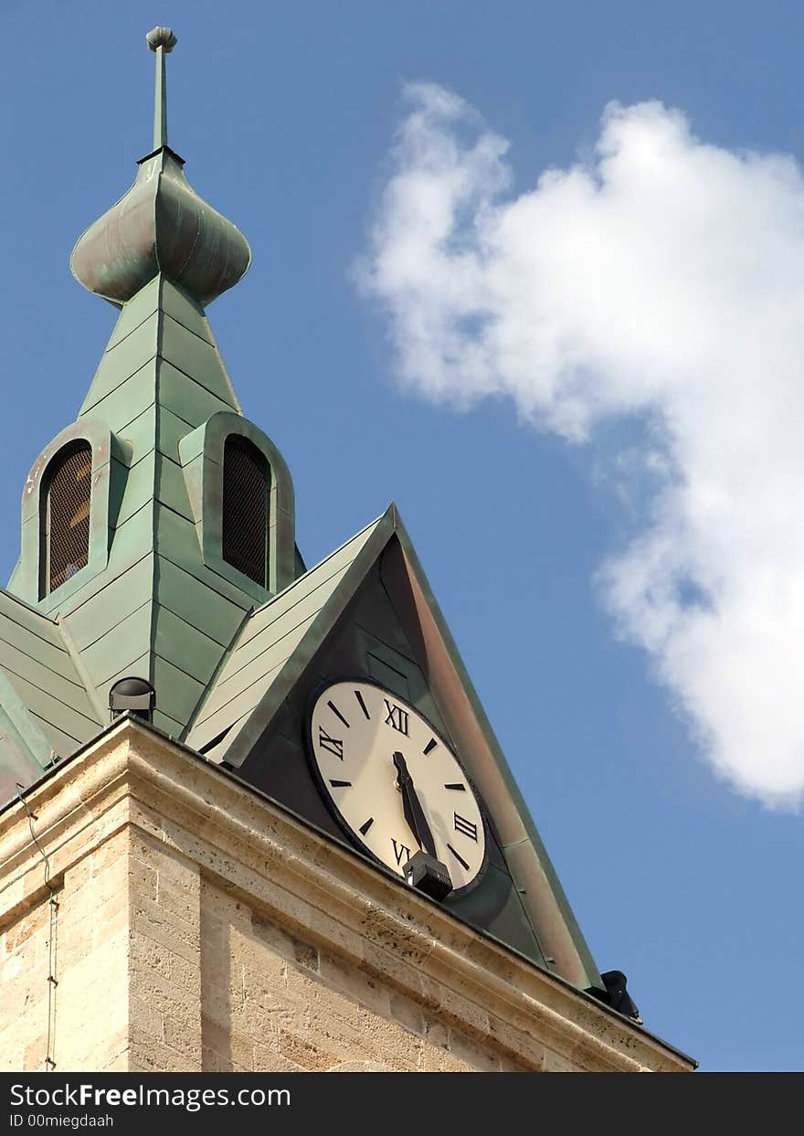 Fragment of tower with clock, sky and cloud in background. Fragment of tower with clock, sky and cloud in background