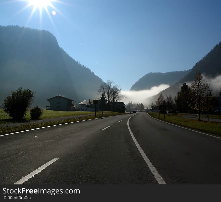 Alpes, Bavaria, Germany - Inzell City . Highway to Mountains . In the distance - the mist in the Gorge . Alpes, Bavaria, Germany - Inzell City . Highway to Mountains . In the distance - the mist in the Gorge .