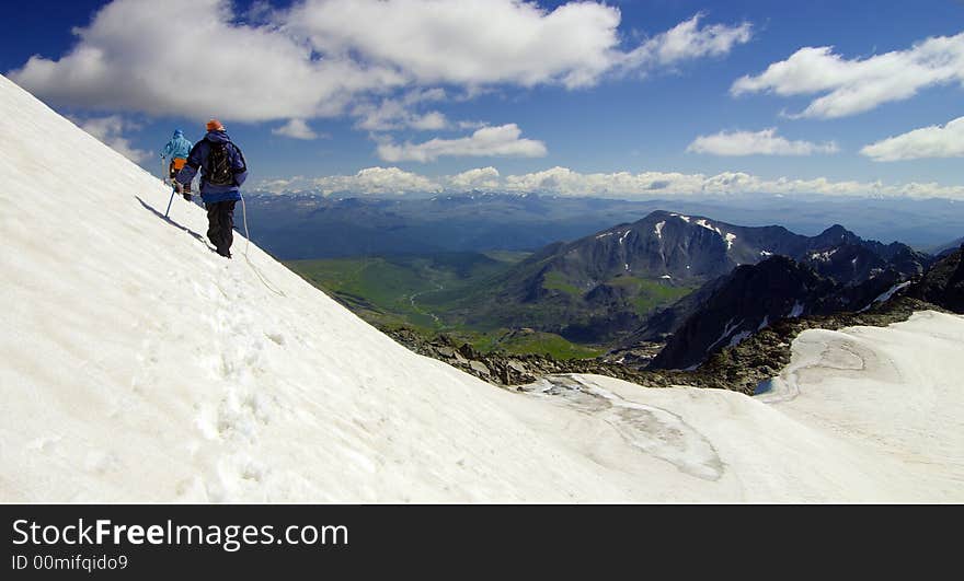 Two climbers high above the wild valley. Two climbers high above the wild valley