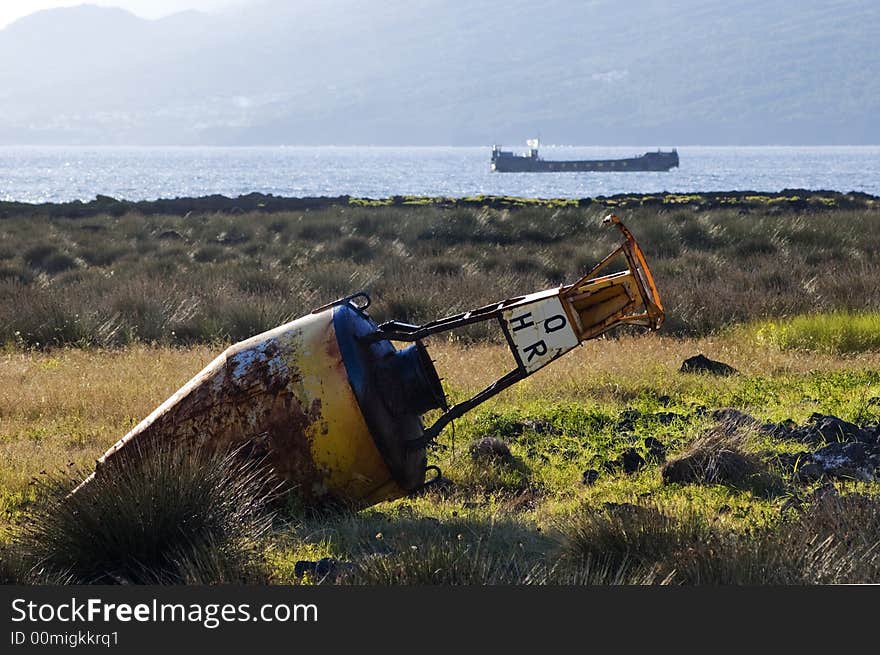 Old beacon buoy on the shore