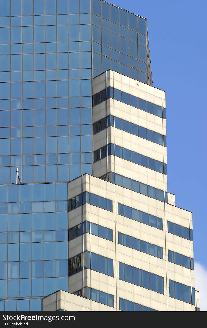 Manhatten skyscraper against a blue sky. Manhatten skyscraper against a blue sky