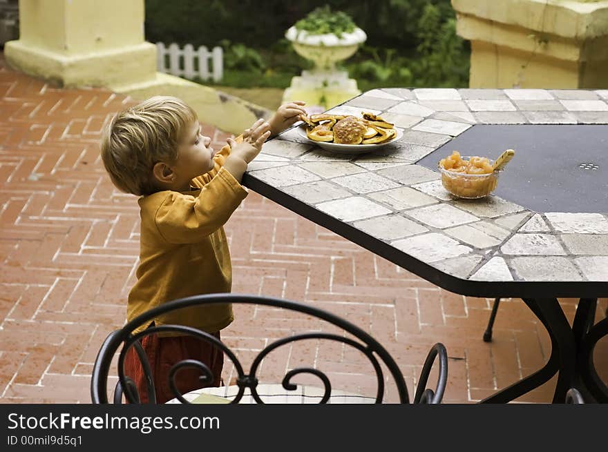 Beautiful little girl is eating pancakes. Beautiful little girl is eating pancakes