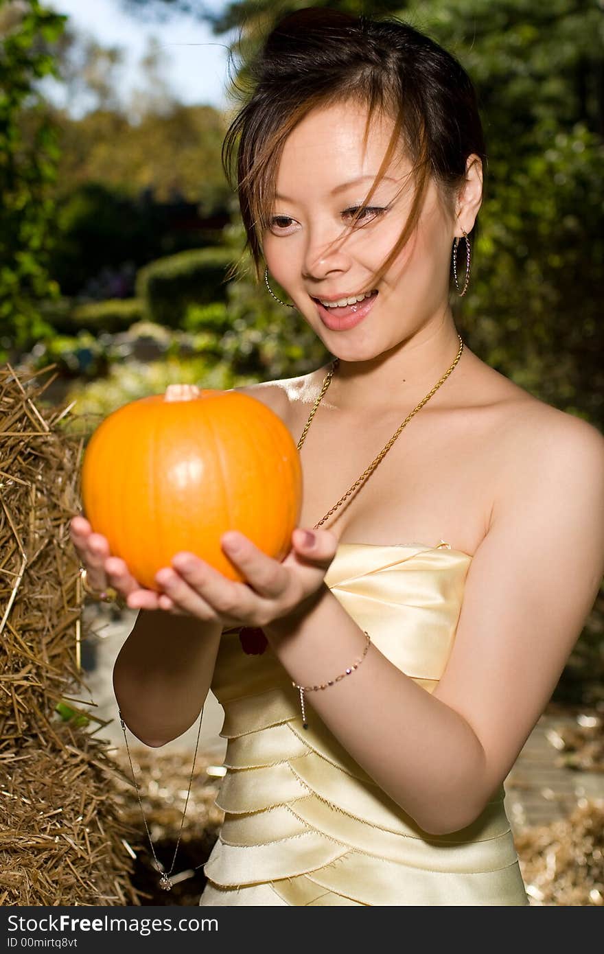 A girl watching a pumpkin surprisingly. A girl watching a pumpkin surprisingly