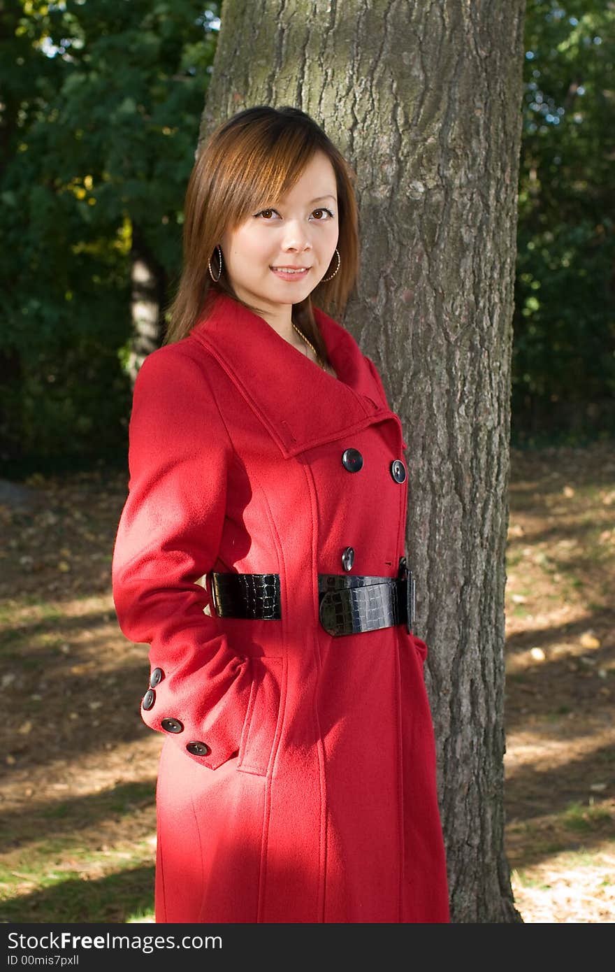 A quite girl in red rest herself in forest