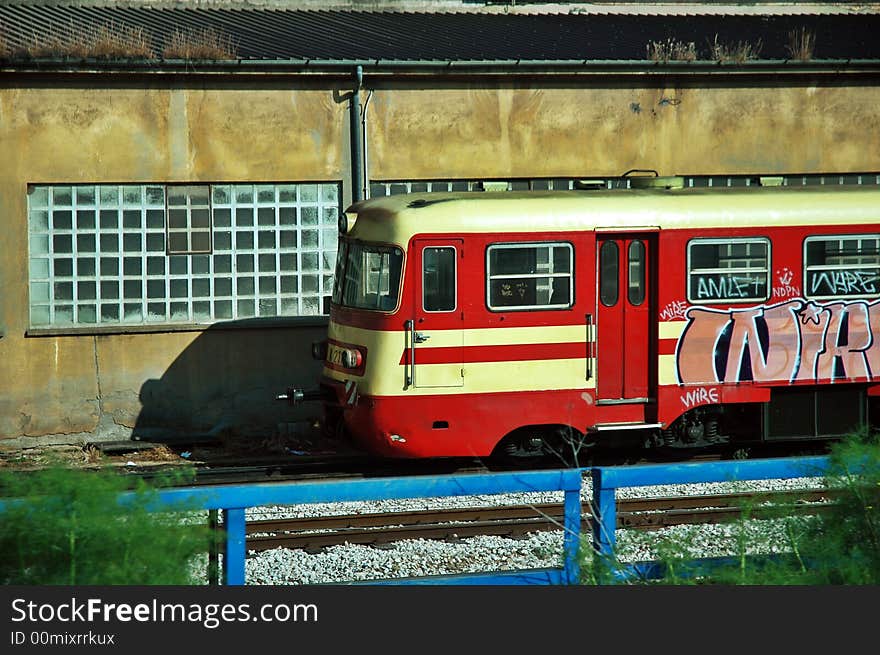 Red train locomotive with graffiti