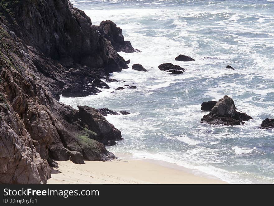 Ocean scenic showing wave action and rocks, sand at a beach in California. Ocean scenic showing wave action and rocks, sand at a beach in California.