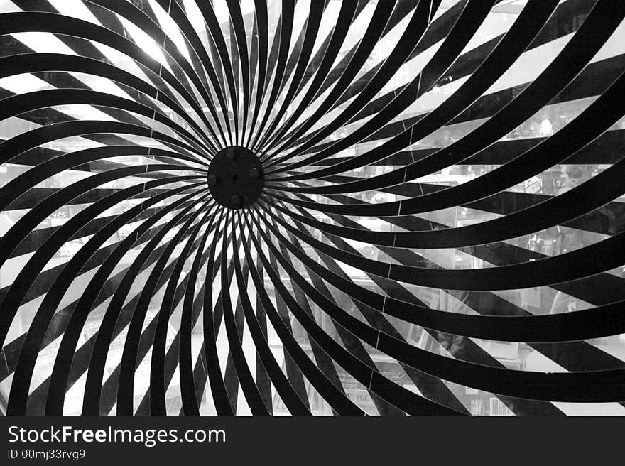 Abstract metal pinwheel structure in black and white.