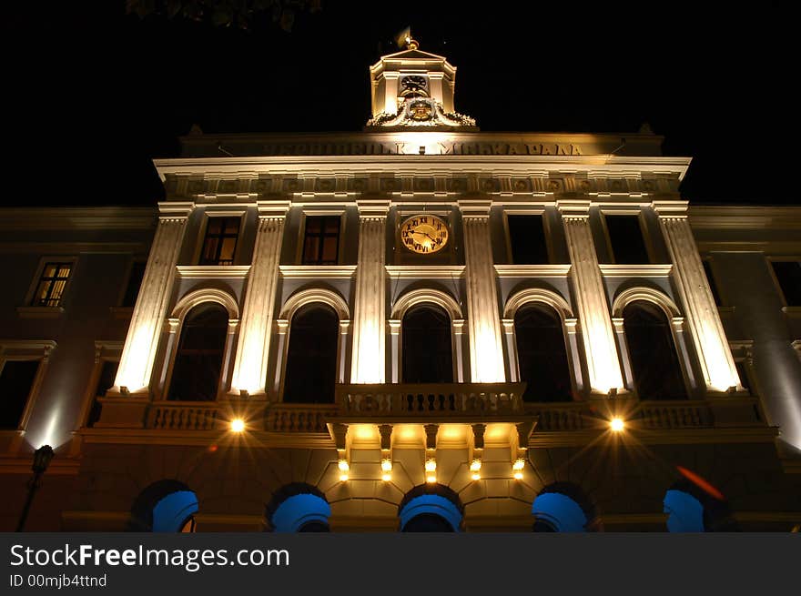 Night look of the administrative building with the balcony and clock. Night look of the administrative building with the balcony and clock