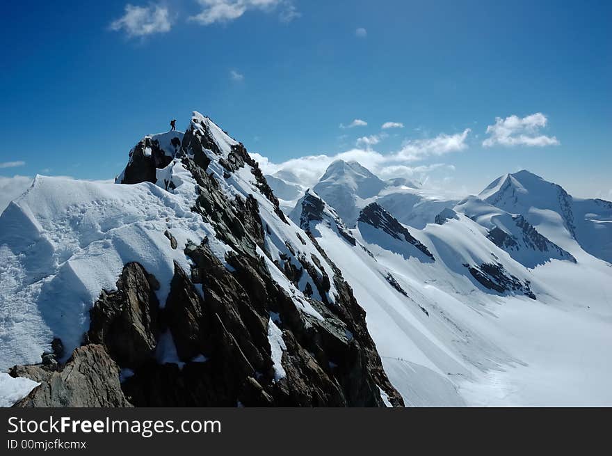 Climbers, on background the peaks and glaciers of Monte Rosa massif, west Alps, Europe. Climbers, on background the peaks and glaciers of Monte Rosa massif, west Alps, Europe