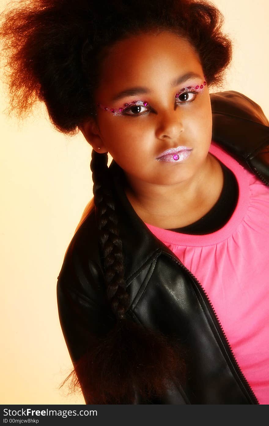 Beautiful ten year old African American girl with artistic cosmetics. Beautiful ten year old African American girl with artistic cosmetics.