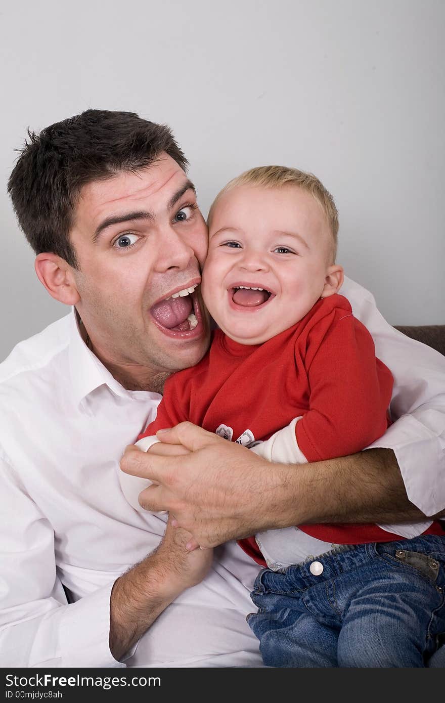 Father and son playing at home. Father and son playing at home