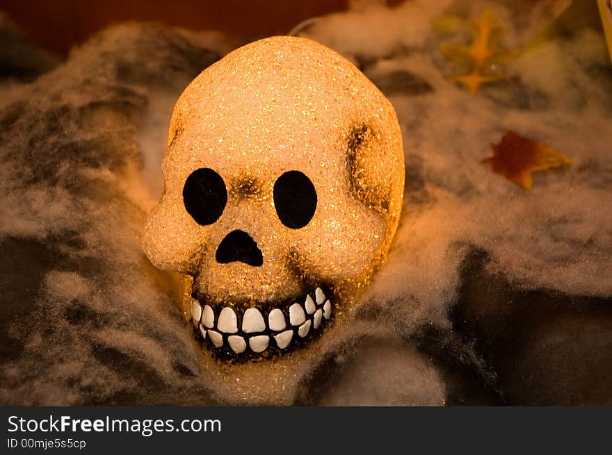 A view of a glowing, smiling skull in an ethereal Halloween setting. A view of a glowing, smiling skull in an ethereal Halloween setting.