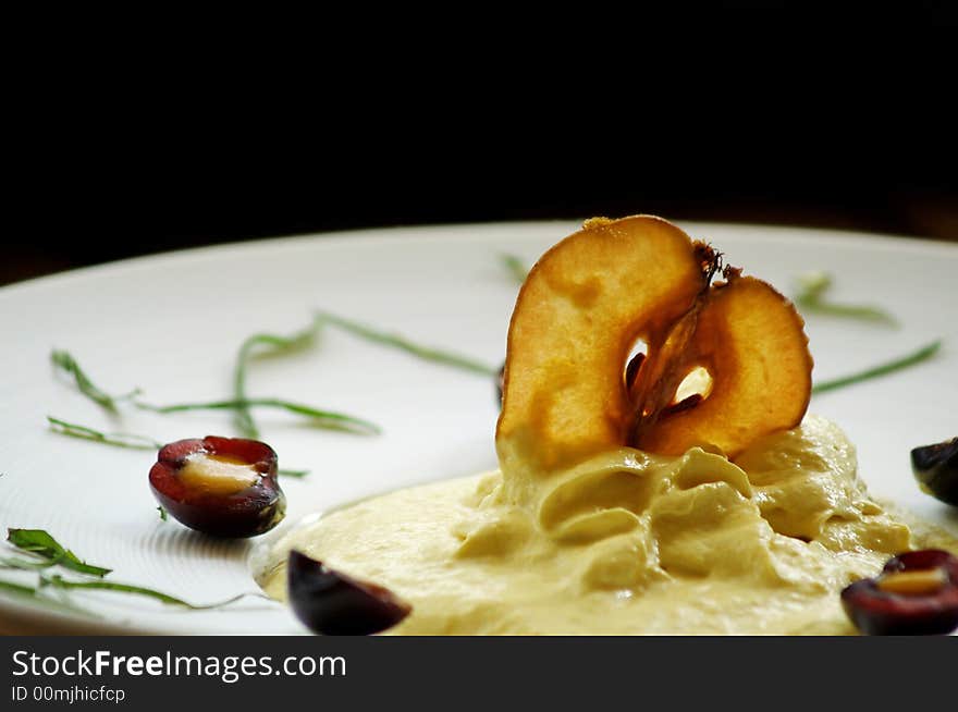 Apple mousse decorated with dried apple and cherry. Apple mousse decorated with dried apple and cherry