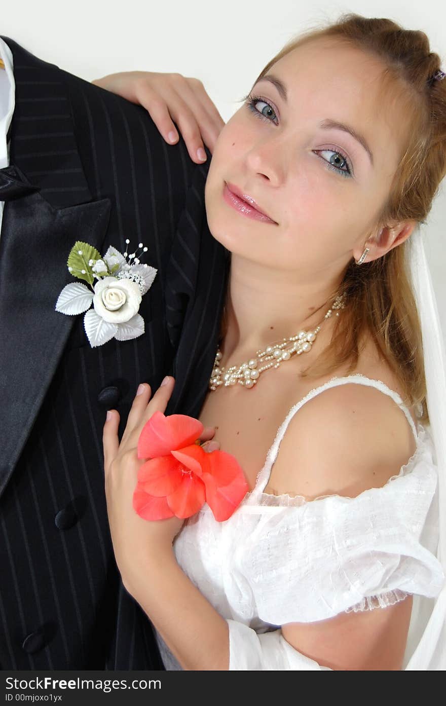 Girl with flower on shoulder of her bridegroom. Girl with flower on shoulder of her bridegroom