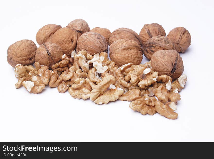 Golden walnuts, hazel on the white background