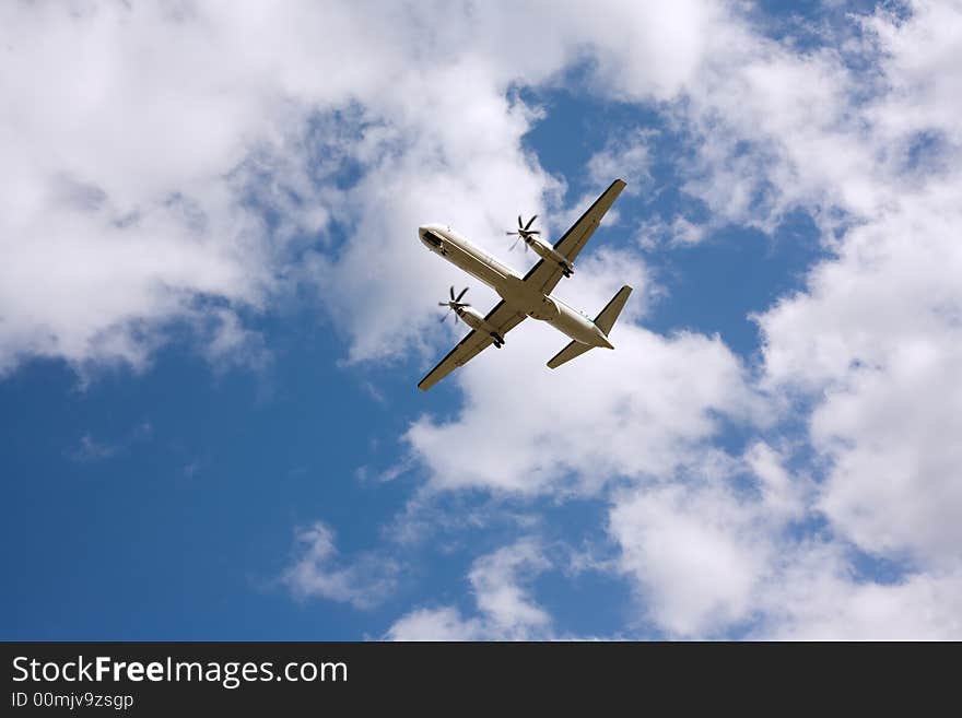 Airplane taking off, blue skies, back view